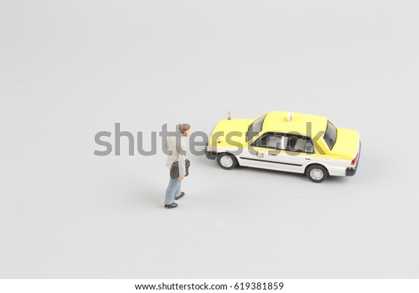 tiny of toy taxi\
with the traveler figure