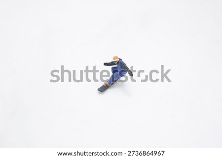 Tiny winter figurine carves dynamic motion in clean studio