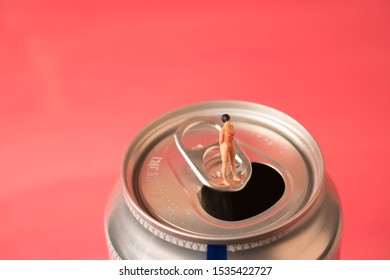 Tiny Woman On A Soda Can. Sugar Drink Or Cola Addiction.  Consumption Of Fizzy Drinks Are Bad For Diet And Health. Quitting Soda Habit Can Be Challenging. 