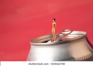 Tiny Woman On A Soda Can. Sugar Drink Or Cola Addiction.  Consumption Of Fizzy Drinks Are Bad For Diet And Health. Quitting Soda Habit Can Be Challenging. 