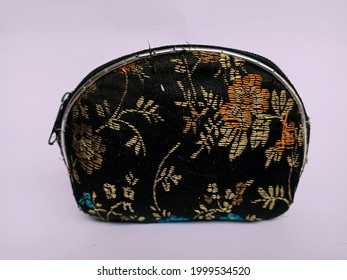 A Tiny Women's Purse Made Of Flower-patterned Fabric