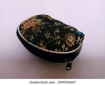 A Tiny Women's Purse Made Of Flower-patterned Fabric