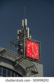 tip of a building with red clock