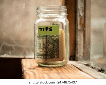 Tip jar with dollars in the window medium shot selective focus