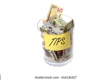Tip Jar. Tip Jar stuffed with money. Isolated on white with room for your text.