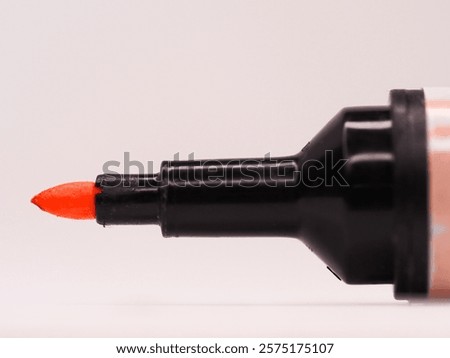 The tip of an orange felt pen