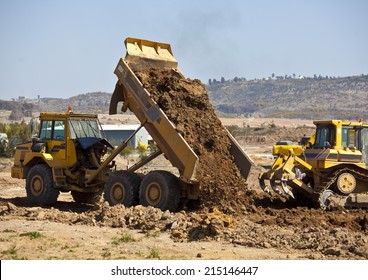 Tip Truck And Ripper At Work Preparing Ground For New Housing Estate