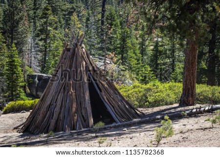A tipi built out of branches and logs at the beginning of a hiking trail near Lake Tahoe. 