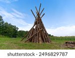 Tipi shaped tree trunks of bonfire ready for national holiday of Switzerland on meadow at Swiss City of Zürich on a summer morning. Photo taken August 1st, 2024, Zurich, Switzerland.