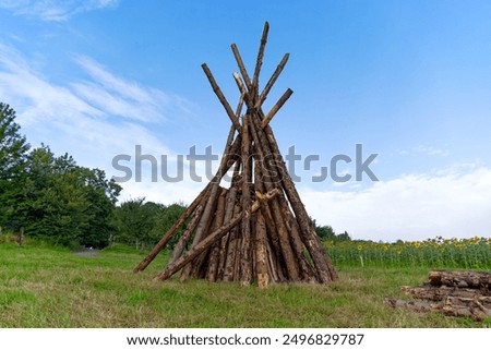 Tipi shaped tree trunks of bonfire ready for national holiday of Switzerland on meadow at Swiss City of Zürich on a summer morning. Photo taken August 1st, 2024, Zurich, Switzerland.