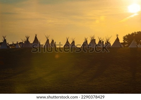 tipis at sunset in the prairie