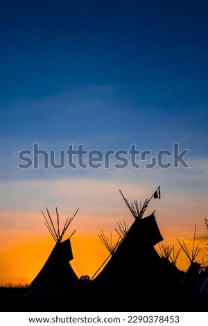 tipis at sunset in the prairie