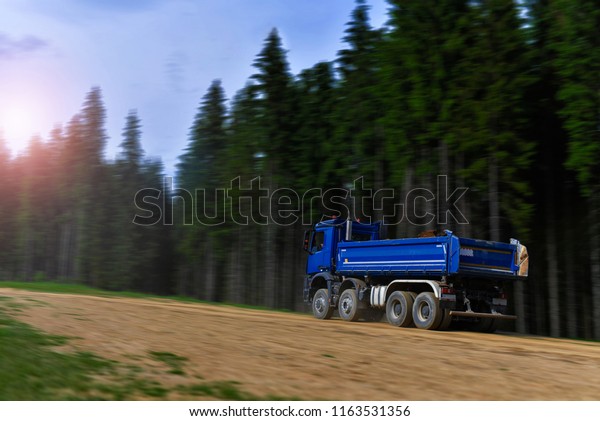 a tipper truck\
carry a soil in mountains