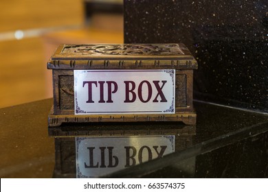 The tipping box is on the counter of the hotel's recipes. Hotel in Turkey. Grateful tourists leave small bills and coins for hotel or restaurant employees.