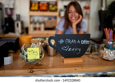 tips jar and grab sign for coffee at new open cafe.