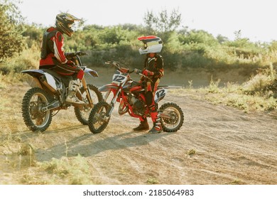 Tips and tricks. Live shot of junior sportsman, motorcyclist training on motorbike at hot summer day, outdoors. Motocross sport, competition, male hobby, energy and ad