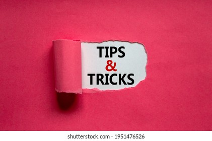 Tips and tricks symbol. Words 'Tips and tricks' appearing behind torn orange paper. Beautiful purple background. Business, Tips and tricks concept. Copy space.