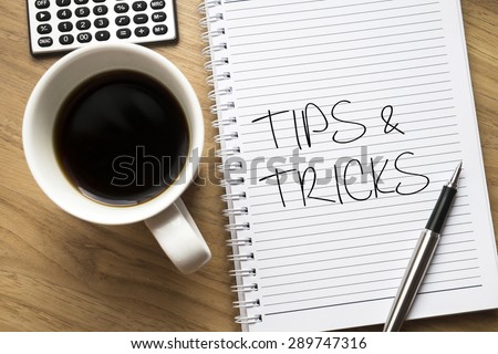 Tips and tricks written on book with wooden background