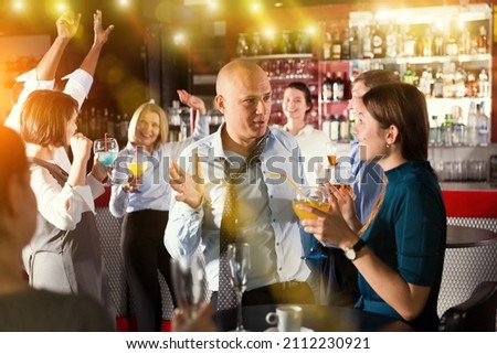 Similar – Image, Stock Photo Young business people on the roof terrace at the Afterwork Beer