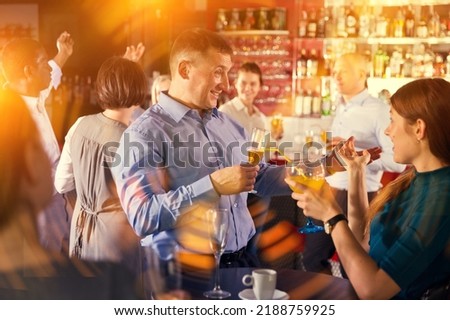 Tipsy businessman with young female colleague fooling during office party at nightclub Foto stock © 