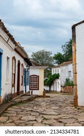 TIRADENTES, MINAS GERAIS - BRAZIL: OCT 20, 2016: Opposite view of Padre Toledo street with colorful colonial houses, nearby Santo Antonio mother church in Tiradentes historical center.