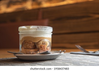 Tiramisu With Banana In Transparent Glass.