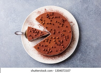 Tiramisu Cake With Chocolate Decotaion On A Plate. Grey Stone Background. Top View.