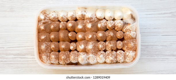 Tiramisu Ice Cream In Plastic Box, Overhead. Flat Lay, From Above, Top View.