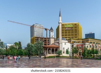 Tirana, Albania - June 21, 2021: View From Skanderbeg Square On Modern And Ancient Architecture In Tirana. People Walk On The City Street On The Backdrop Of Ethem Bey Mosque, Clock Tower And TID Tower