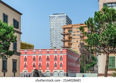 Tirana, Albania - June 21, 2021: View of the pink building of the Ministry of Agriculture on the backdrop of the TID Tower skyscraper in Tirana. Modern and ancient architecture in the Albanian capital