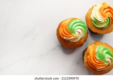 Tiranga Cupcake or Tricolor Cupcake with Indian National Flag colors frosting. saffron or orange, white and green. The concept for Indian happy Independence or Republic day greeting card. copy space.