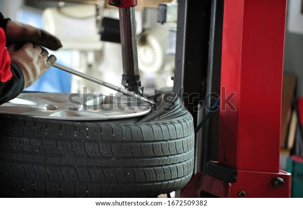 Tire change work on a\
car