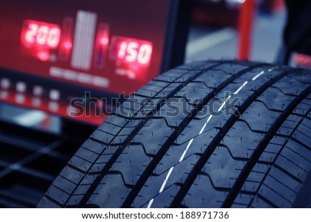 Tire check on balancing machine.Blue toned photo