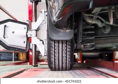 Tire Clamped With Aligner Undergoing Auto Wheel Alignment 