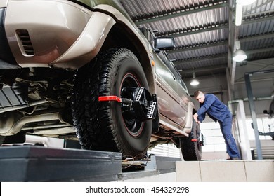 Tire Clamped With Aligner Undergoing Auto Wheel Alignment In Garage. Electronic Tuning Of Car