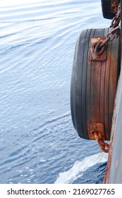 Tire Fenders Made Of Large Vehicle Tires. Mounted On The Ship's Hull To Reduce The Effects Of The Ship's Impact, Or When The Ship Is Touching The Jetty At Port, Against Calm Sea With Little Wave