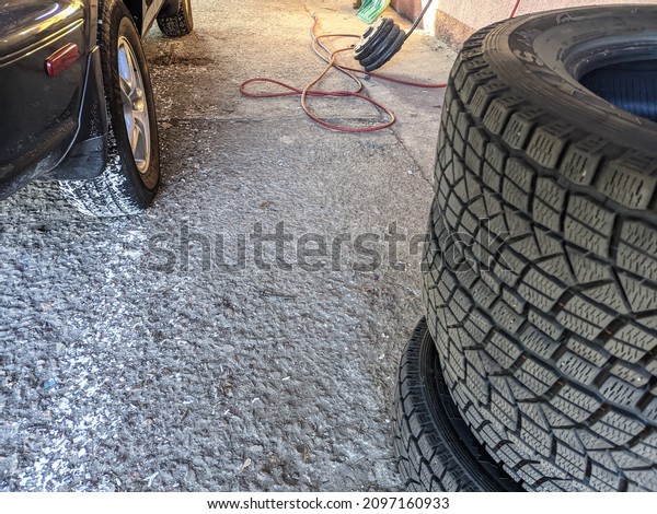 tire\
fitting. tire repair. Car mechanic worker doing tire or wheel\
replacement in garage of repair service station. Car mechanic\
changing tire in professional car repair\
service.