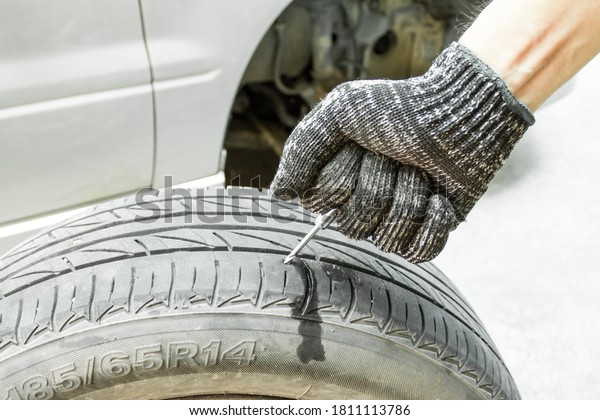 Tire mechanic use Rasper Tool to repair car\
tire, Car service.