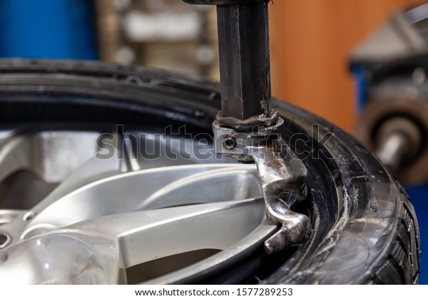 Tire mounting of car wheels on special equipment\
during removal of a tire from a disk by a hook before winter after\
summer and vice versa.