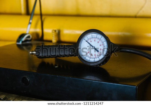 Tire Pressure Gauge \
on yellow background