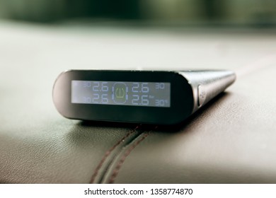 Tire Pressure Monitoring Instrument Is Testing Tire Pressure In The Car