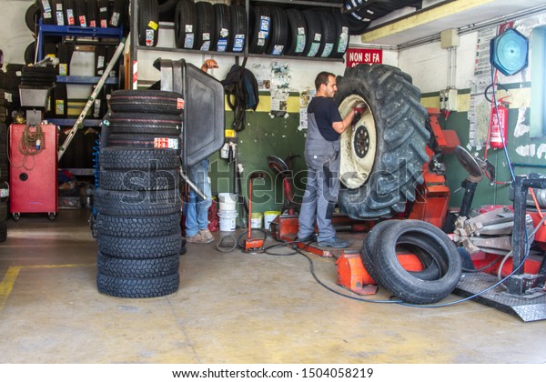tire repairer at work that changes and repairs\
truck and car tires in the garage\
, Perfugas, SS, Italy\
,14/09/2019 Tire repairer