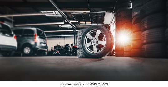 tire at repairing service garage background. Technician man replacing winter and summer tyre for safety road trip. Transportation and automotive maintenance concept  - Powered by Shutterstock