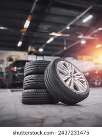 tire at repairing service garage background. Technician man replacing winter and summer tyre for safety road trip. Transportation and automotive maintenance concept