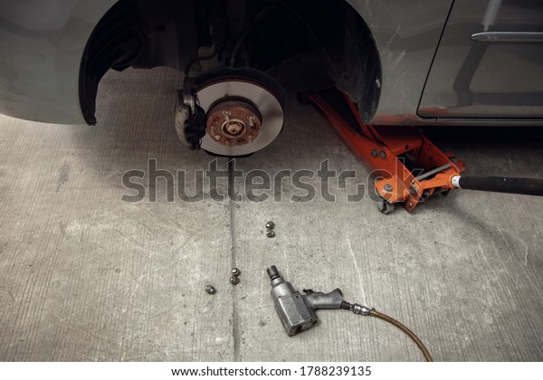 Tire Replacement concept. Garage Tools and\
Equipment. Car Maintenance and\
services