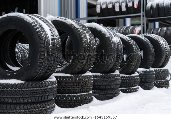 Tire shop on\
the street. Seasonal tire\
change.