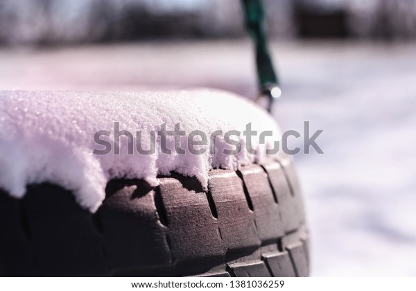 A tire swing during\
the winter months.