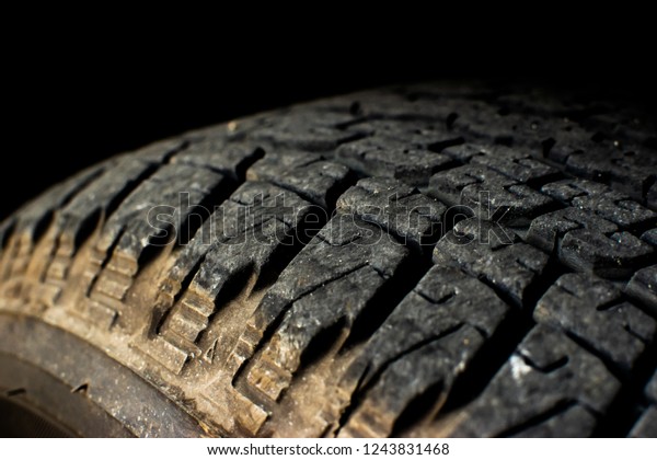 Tire texture on black background, dirty tire\
used for outdoor driving off\
road
