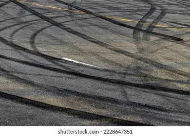 Tire track mark on asphalt tarmac road race track texture and background, Abstract background black tire tracks skid on asphalt road in racing circuit, Tire mark skid mark on asphalt road. - Shutterstock ID 2228647351