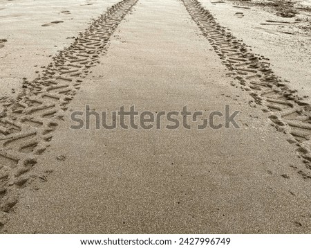 Tire tracks of all terrain vehicle (ATV) on the beach, in Pangandaran Beach, Indonesia